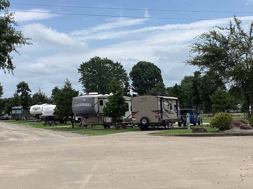 A row of travel trailers in paved sites at LITTLE TURTLE RV & STORAGE