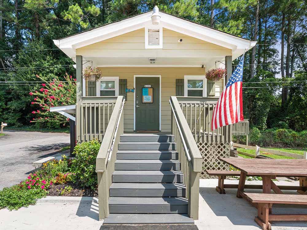 Park model with stairs leading to porch at SWEETWATER CREEK RV RESERVE