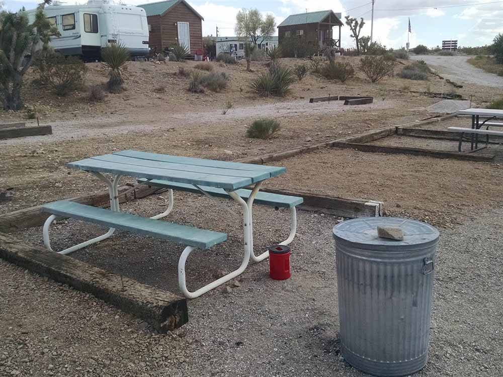 A picnic table and trash can at MEADVIEW RV PARK & COZY CABINS