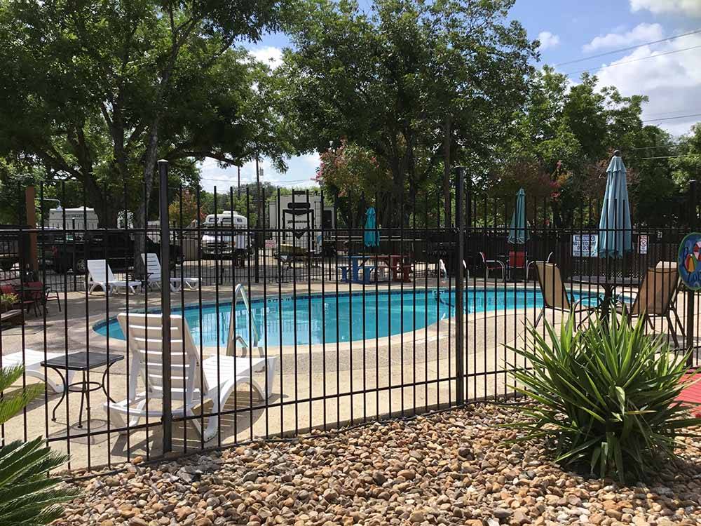 The fenced in swimming pool at MISSION CITY RV PARK
