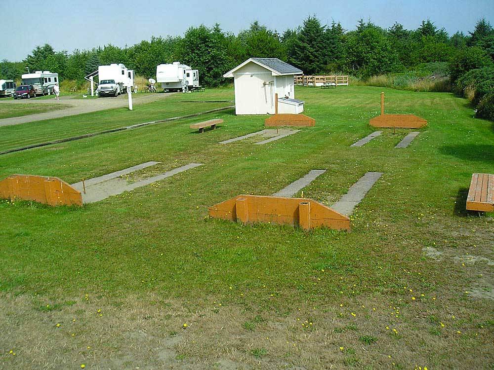Trailers and RVs camping with horseshoe pits nearby at THOUSAND TRAILS OCEANA