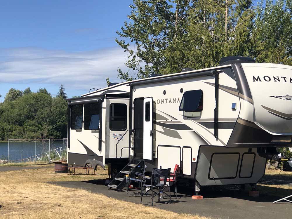 A fifth wheel trailer in a paved RV site at FRIENDS LANDING RV PARK
