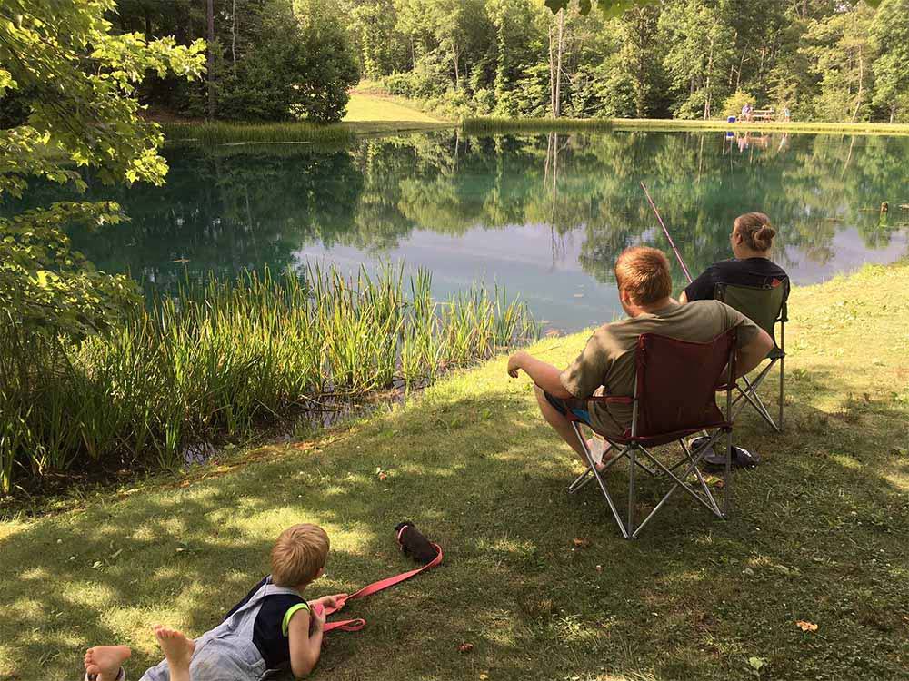 A family fishing in the lake at LAUREL LAKE CAMPING RESORT
