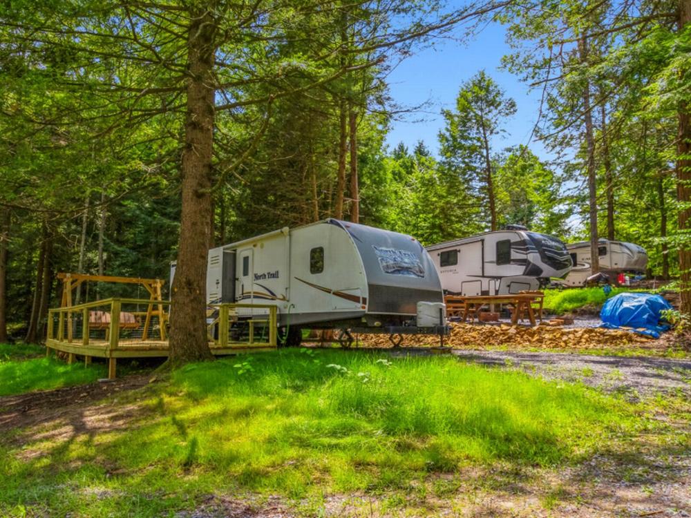 Travel trailers parked in shaded sites