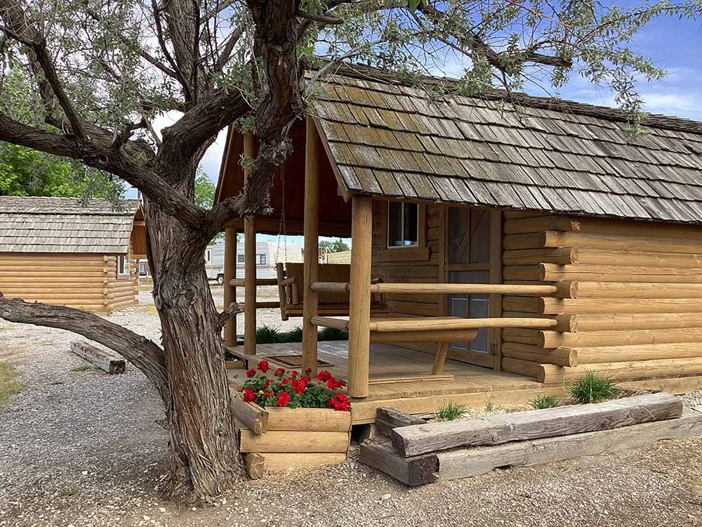 One of the rustic rental log cabins at CHOTEAU MOUNTAIN VIEW RV CAMPGROUND