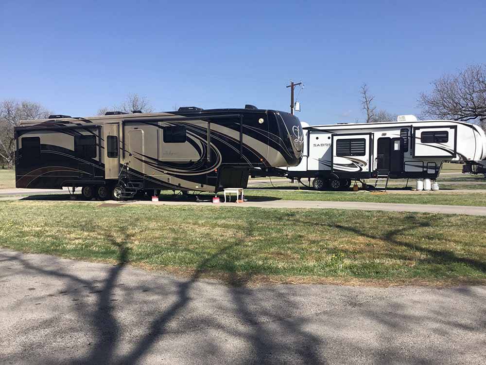 Two fifth wheels parked in RV sites at RIVERSIDE PARK RV