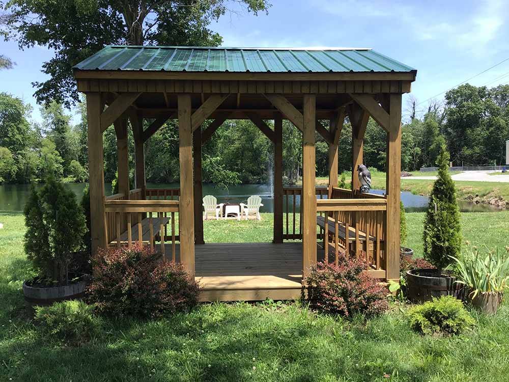 The wooden gazebo with shrubbery at ARCHWAY RV PARK