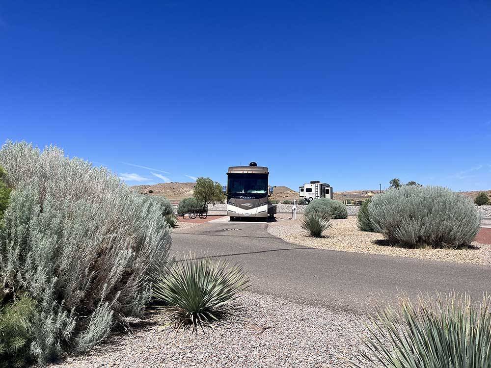 A motorhome parked in a paved site at ROUTE 66 RV RESORT