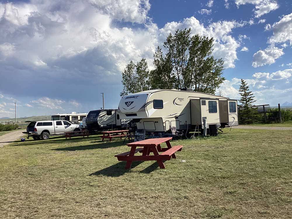 Fifth-wheel on ample site with picnic bench at SLEEPING WOLF CAMPGROUND & RV PARK