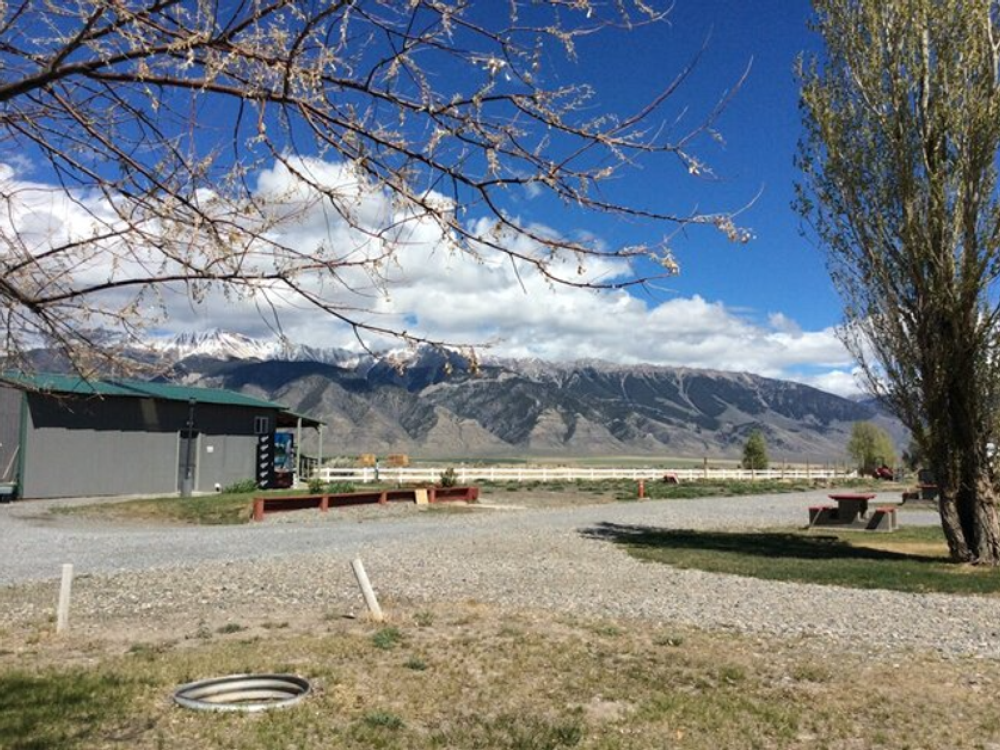 Gravel site with fire ring at Moose Crossing RV Park