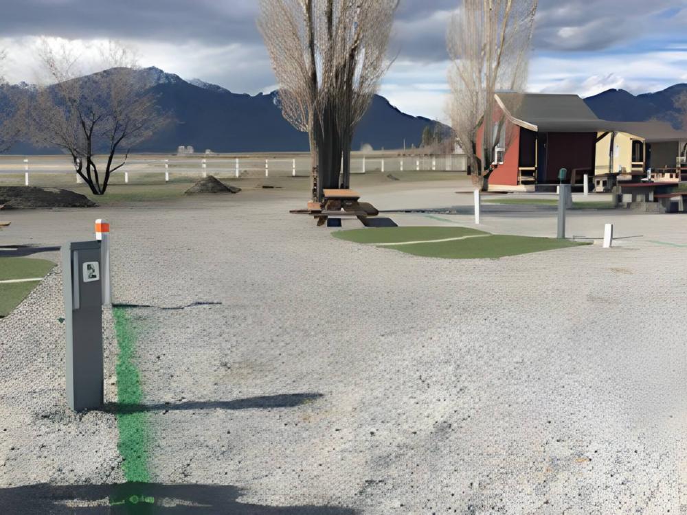 A gravel RV site and one of the rental units
