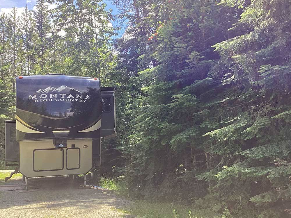 A fifth wheel trailer in a RV site at THE HEMLOCKS RV AND LODGING