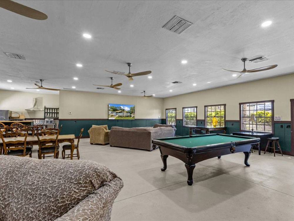 A billiard table and seating in the rec hall