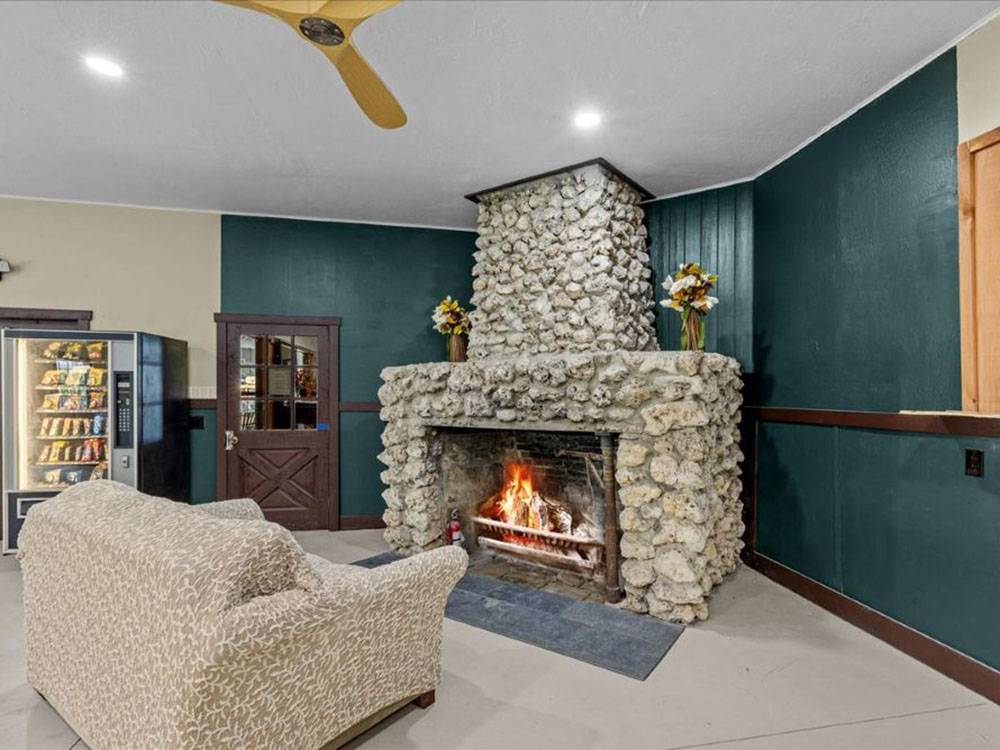 A large stone fireplace in the rec hall