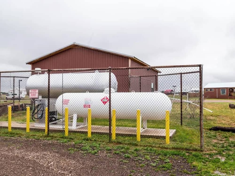 The fenced in propane tank