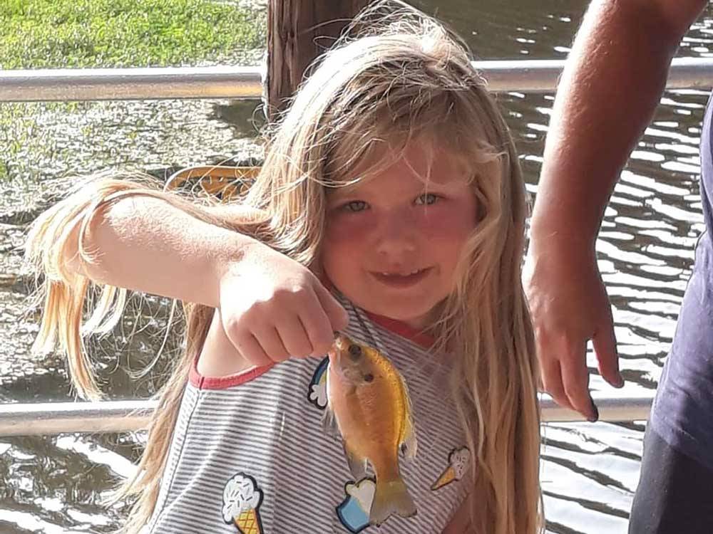 A girl holding a fish at RV CORRAL