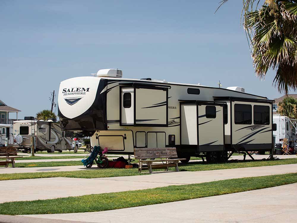 A fifth wheel parked in a RV site at STELLA MARE RV RESORT