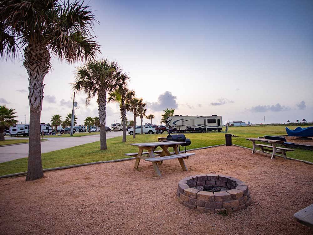 View of bbq pit, fire pit and bench at STELLA MARE RV RESORT