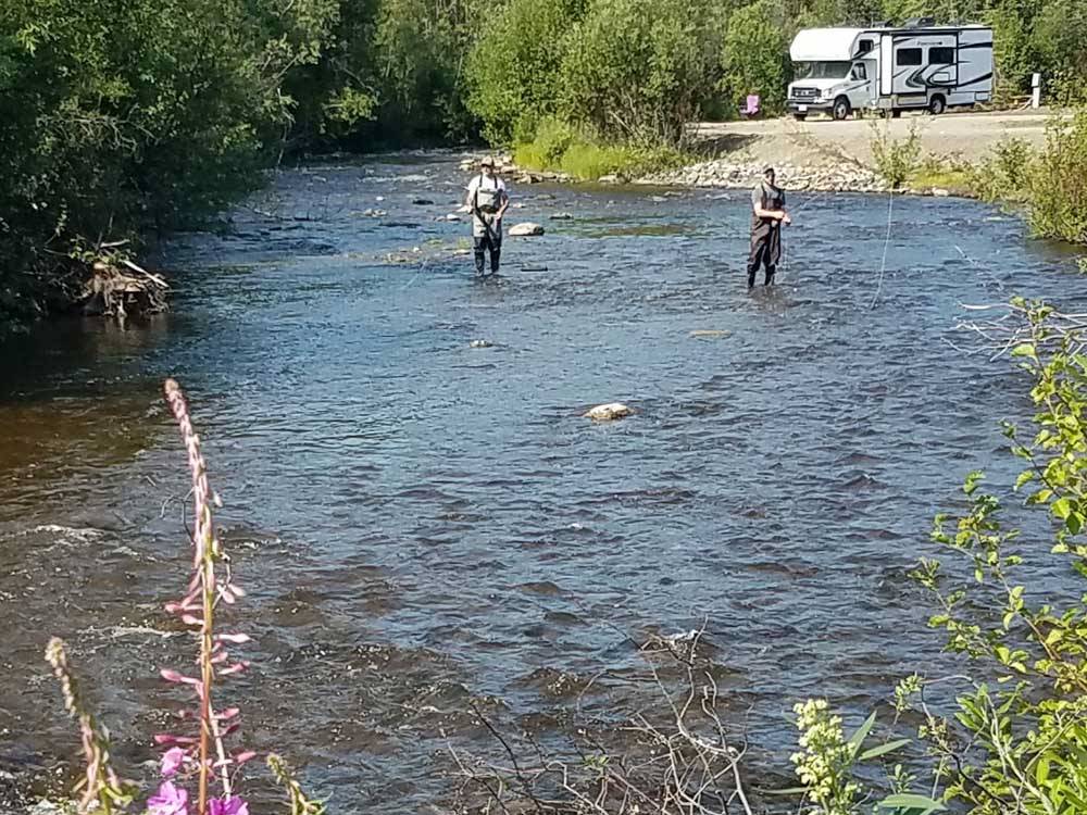 Two men fly fishing at RANCH HOUSE LODGE & RV CAMPING