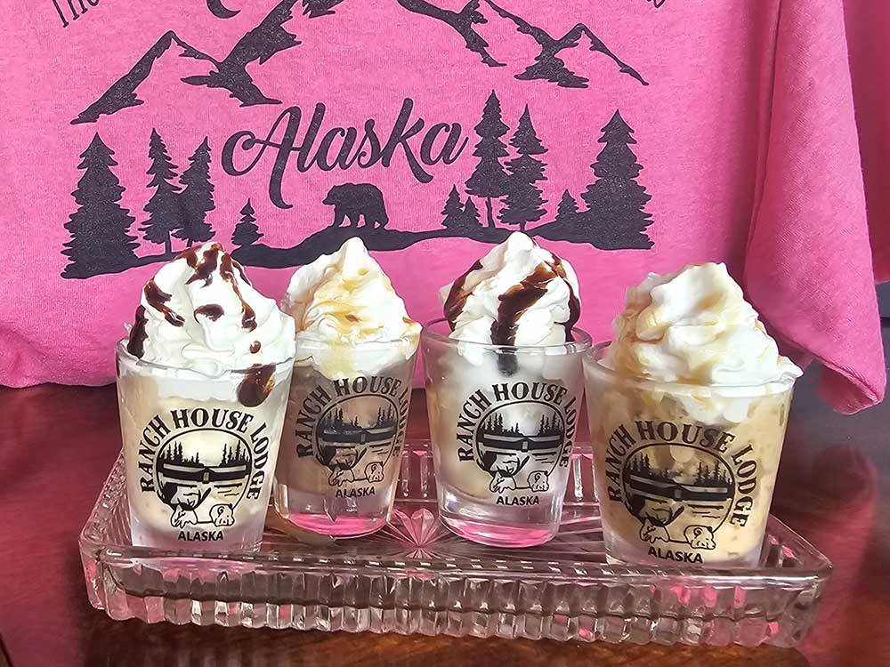 Ice cream sundaes in cups with the park name at RANCH HOUSE LODGE & RV CAMPING