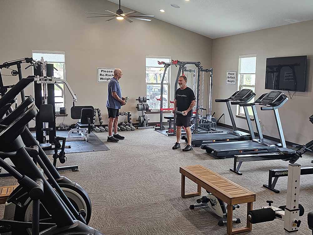 Two men exercising in the exercise room at KEYSTONE HEIGHTS RV RESORT