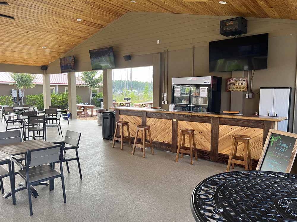 Tables and chairs in the bar area at KEYSTONE HEIGHTS RV RESORT