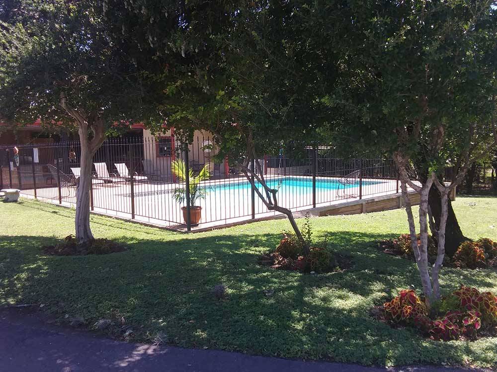 The fenced in swimming pool at TEJAS VALLEY RV PARK