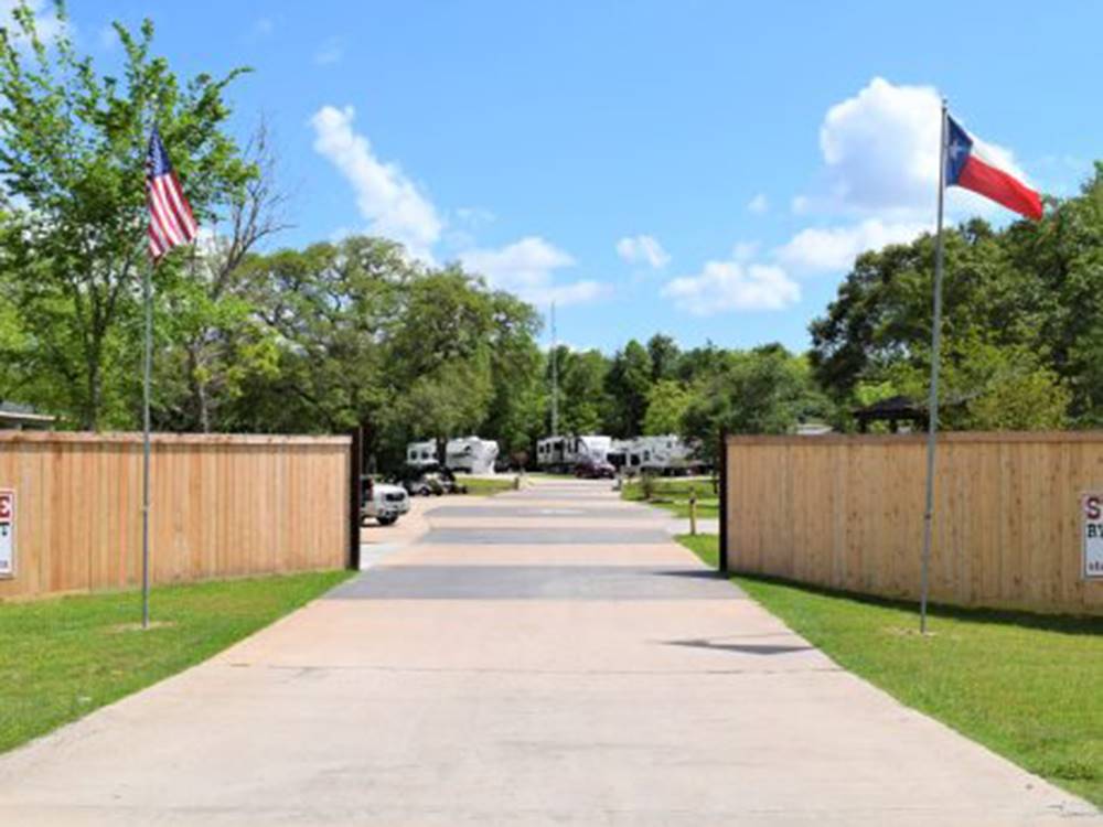 Entrance to park flanked with flags at Stonebridge RV Park & Resort