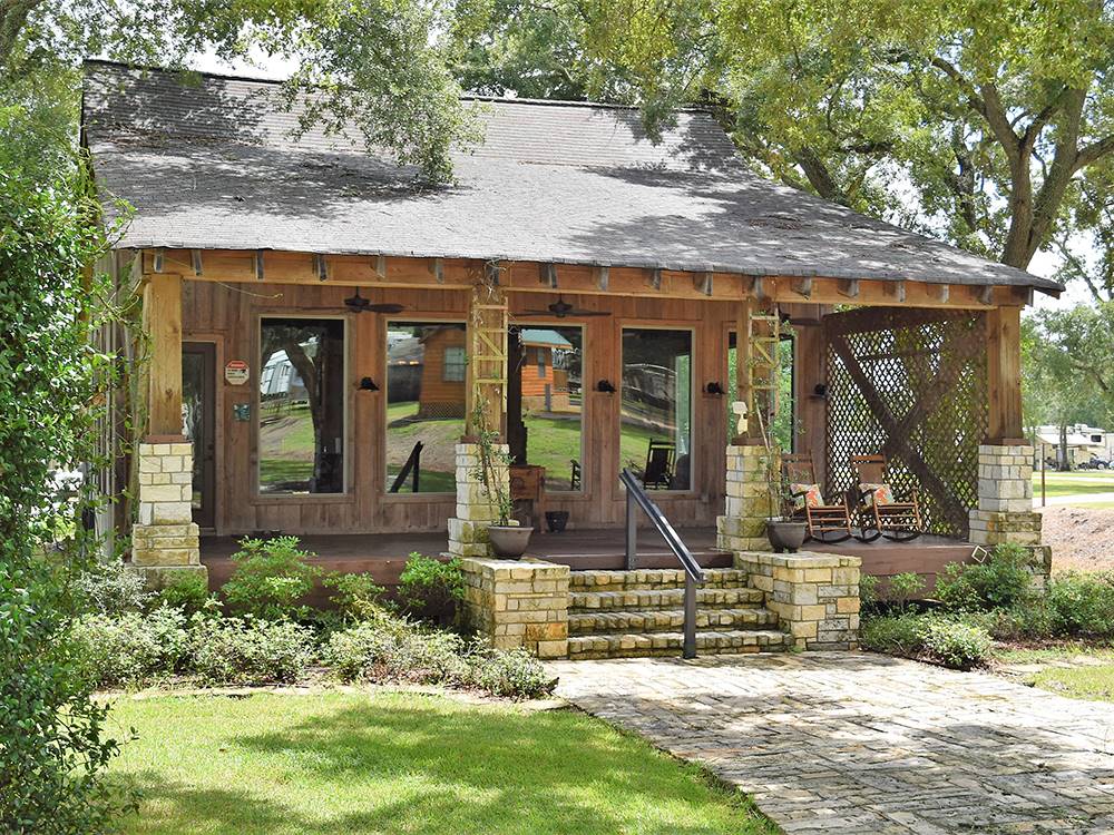 The office building situated under shade trees at Stonebridge RV Park & Resort