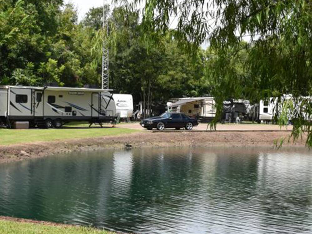 Travel trailers parked around the pond at Stonebridge RV Park & Resort