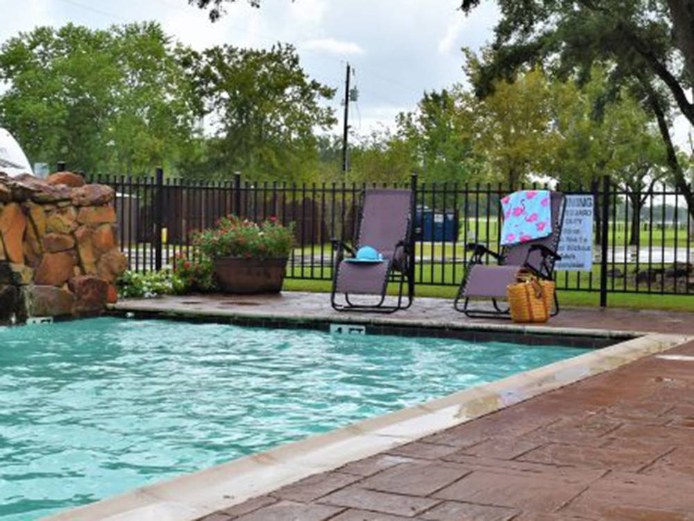 Lounge chairs around the pool at Stonebridge RV Park & Resort