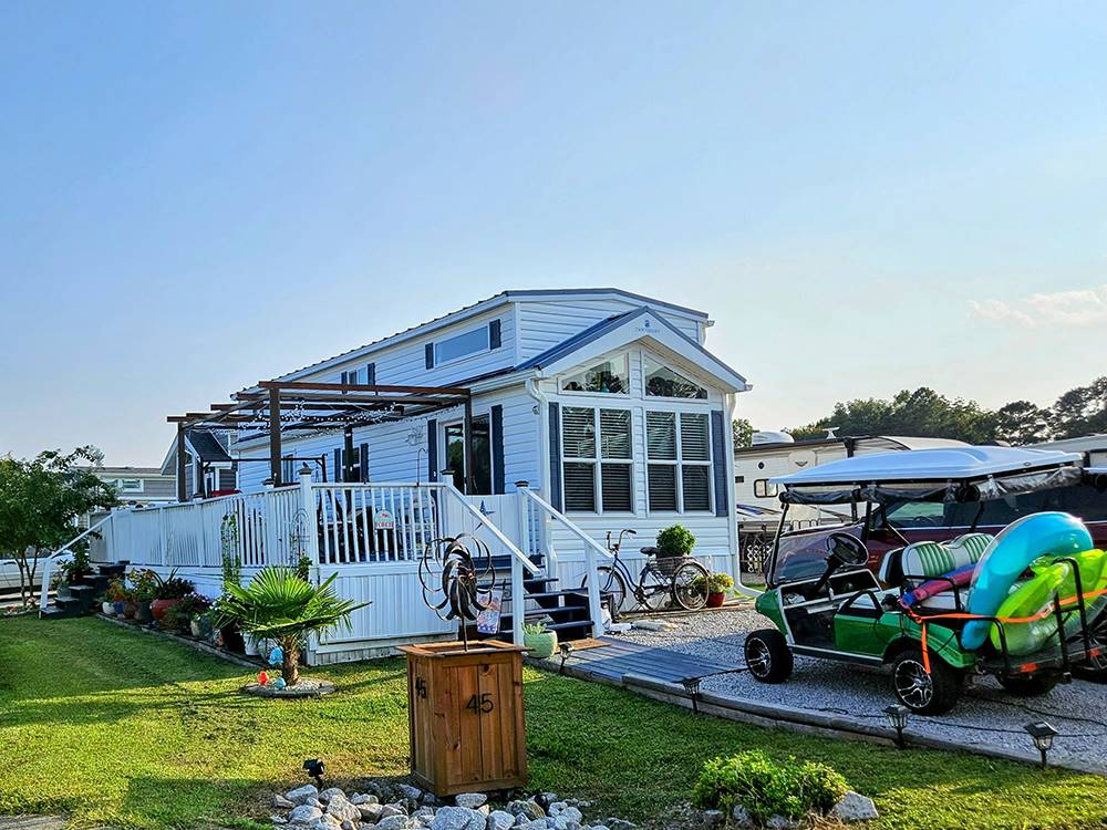 A golf cart parked at a rental at Deep Creek RV Resort & Campground