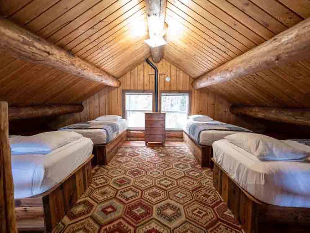 Four single beds in a rental cabin at SHELTER COVE RESORT AND MARINA