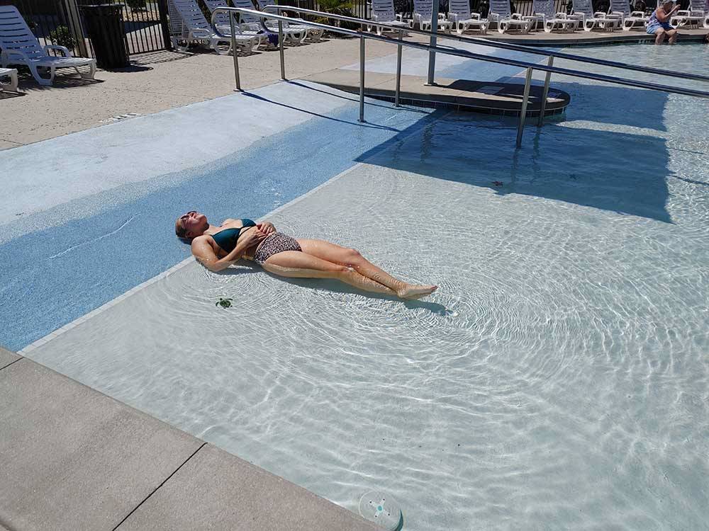 Woman sunning herself in the shallow pool at NMB RV RESORT AND DRY DOCK MARINA