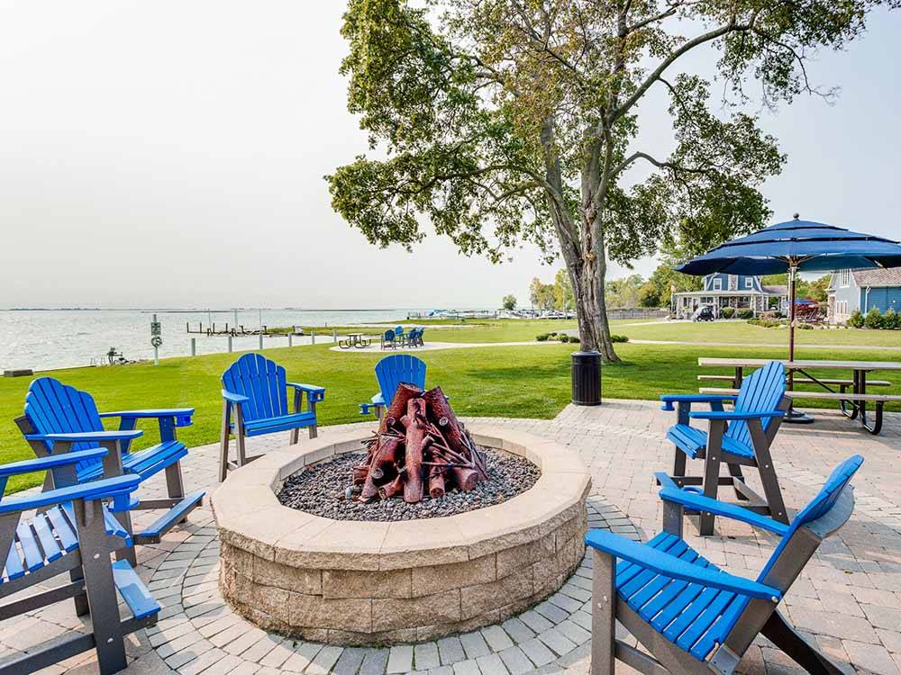 Blue chairs around a fire pit at NORTHPOINTE SHORES RV RESORT
