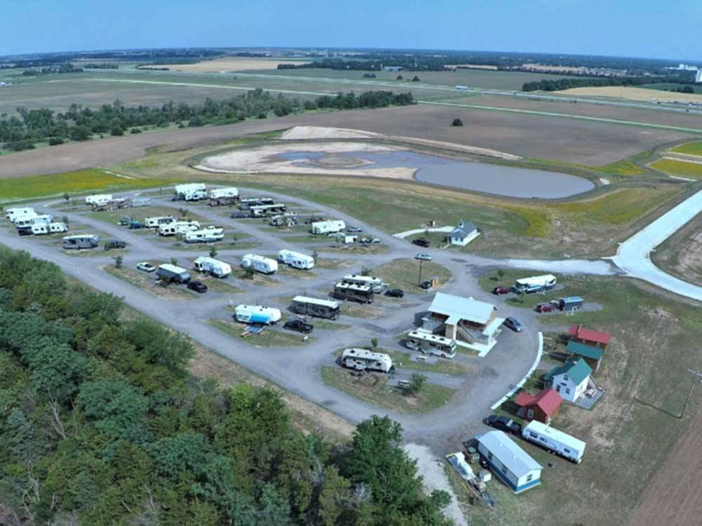 Overhead view of RVs and nearby fields at LIGHTHOUSE LANDING RV PARK & CABINS