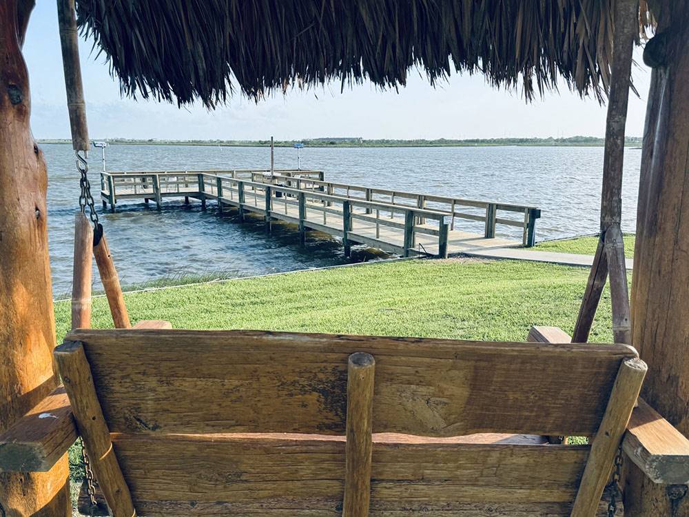 View of the pier from a rustic swing