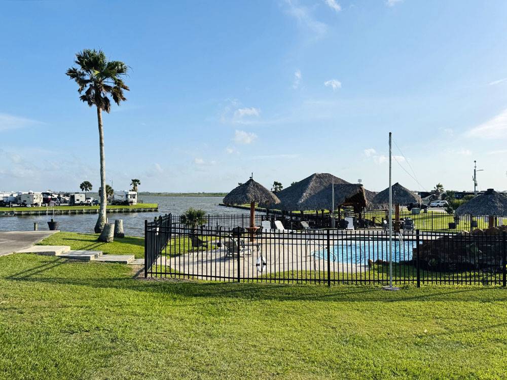 The gated pool with RVs in the background