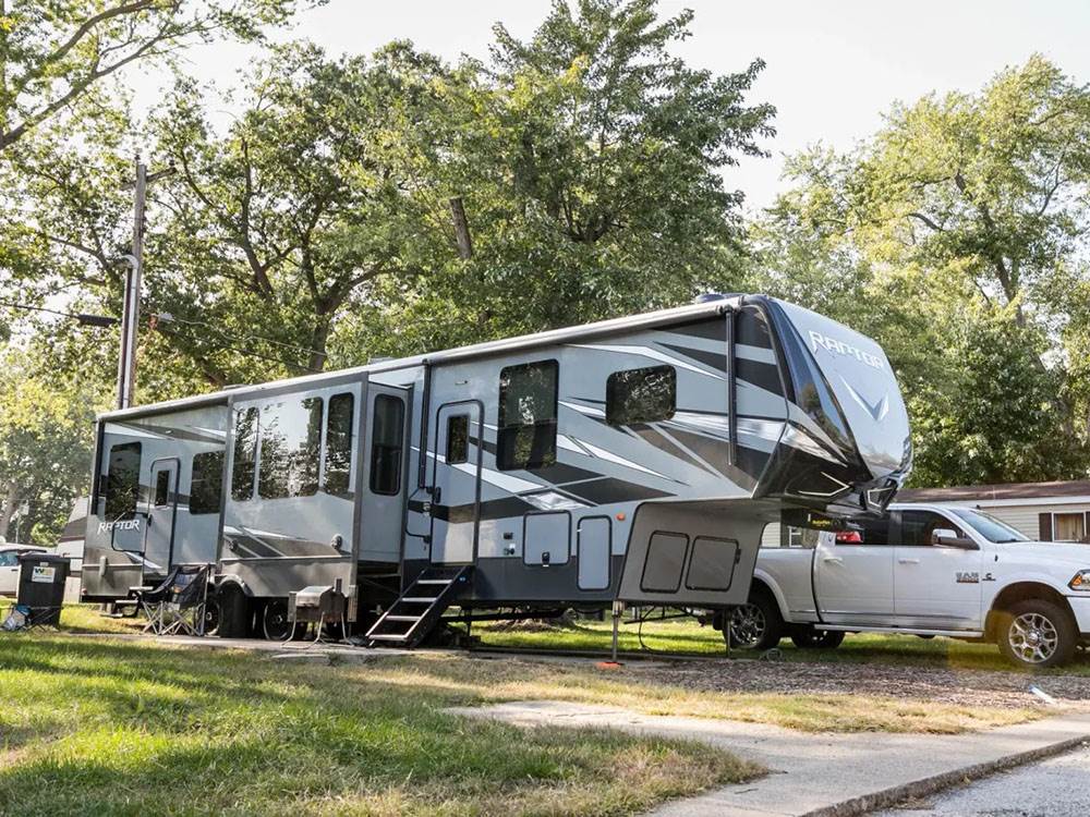 A fifth-wheel RV and truck at site