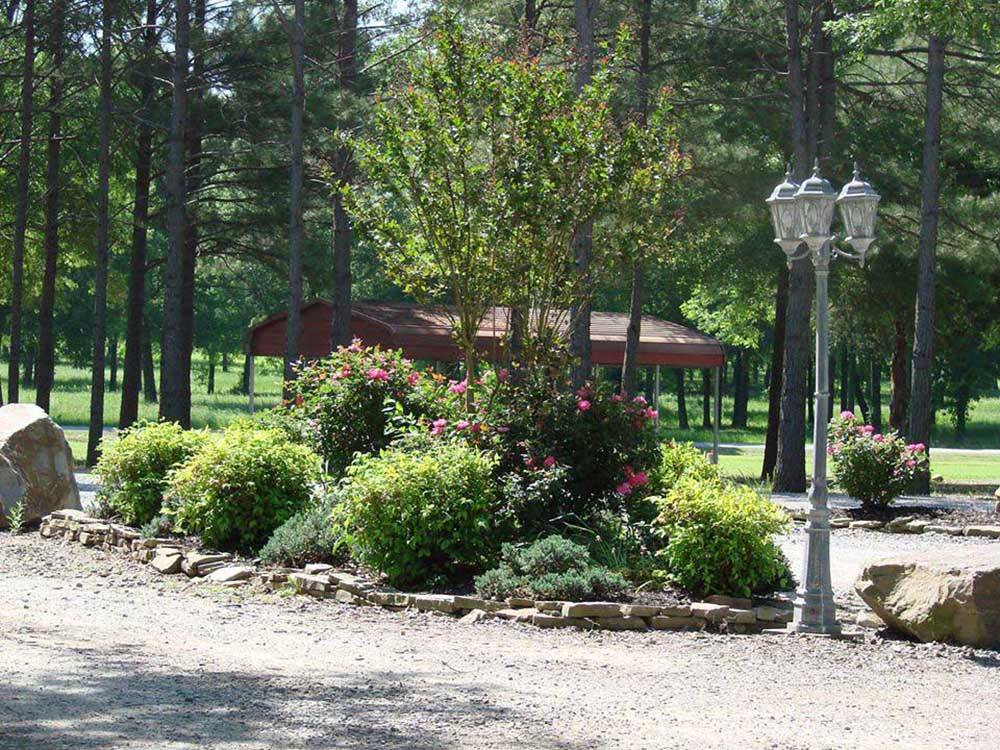 Gravel road with pavilion in distance at RED RIVER RV PARK