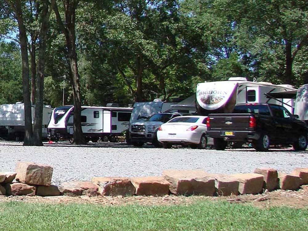 RVs parked on-site near trees at RED RIVER RV PARK
