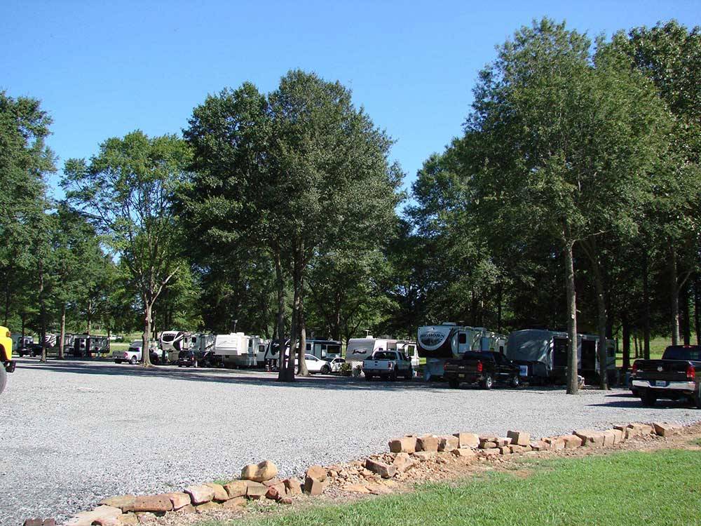 RVs parked under trees at RED RIVER RV PARK