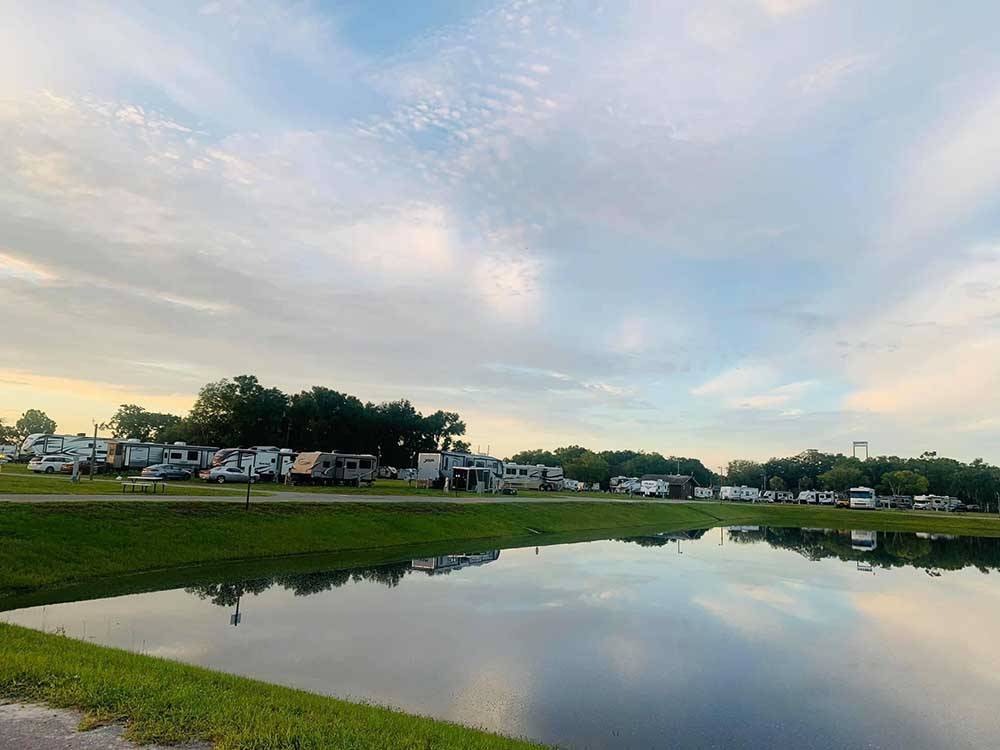 View of water and RVs at sunset at WILDWOOD RV VILLAGE