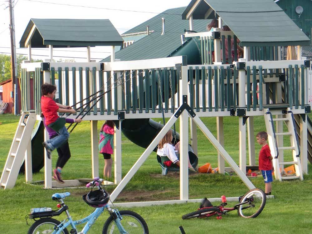 Kids at playground at RIVERSIDE CAMPING & RV RESORT