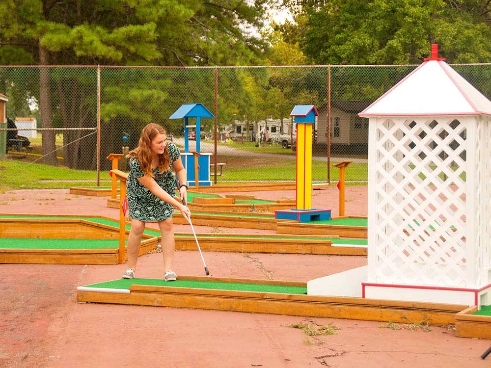 Girl playing at miniature golf course at THOUSAND TRAILS HARBOR VIEW