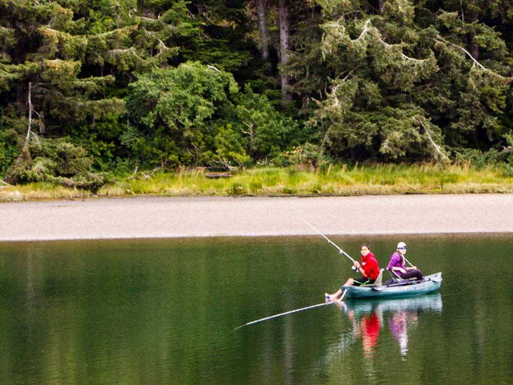 Campers fishing on the lake at THOUSAND TRAILS PACIFIC CITY