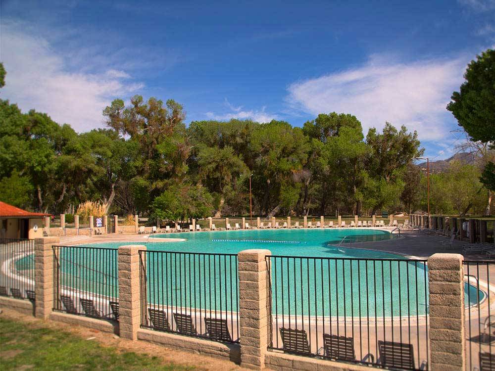 Swimming pool with outdoor seating at THOUSAND TRAILS SOLEDAD CANYON