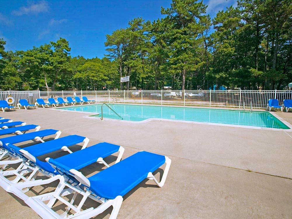Swimming pool with outdoor seating at OLD CHATHAM ROAD RV CAMPGROUND