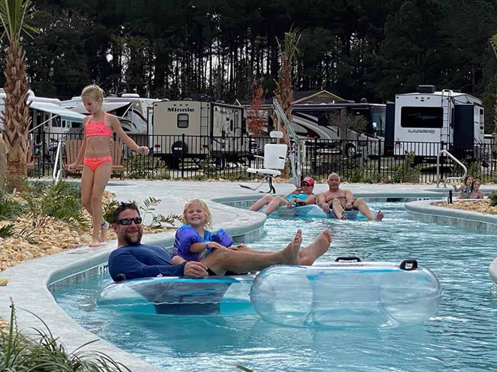 A dad and his daughter enjoying the lazy river at CREEKFIRE RESORT