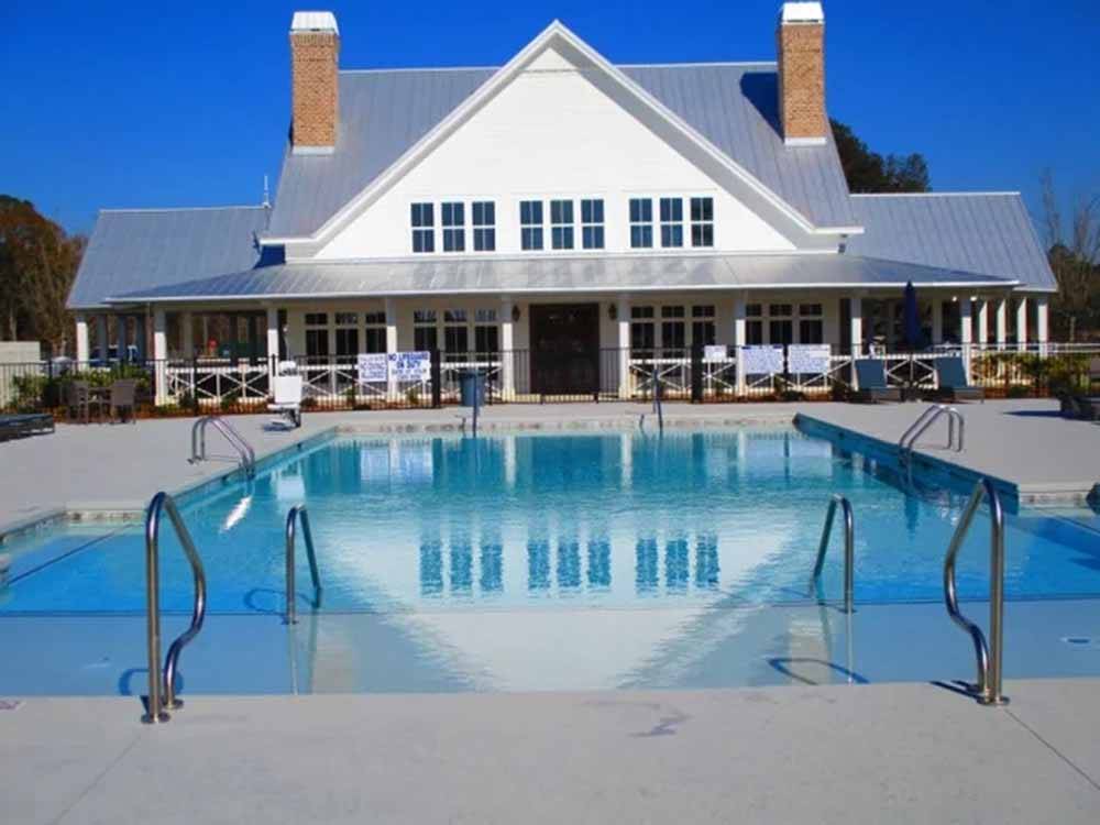 The swimming pool and clubhouse at CREEKFIRE RESORT